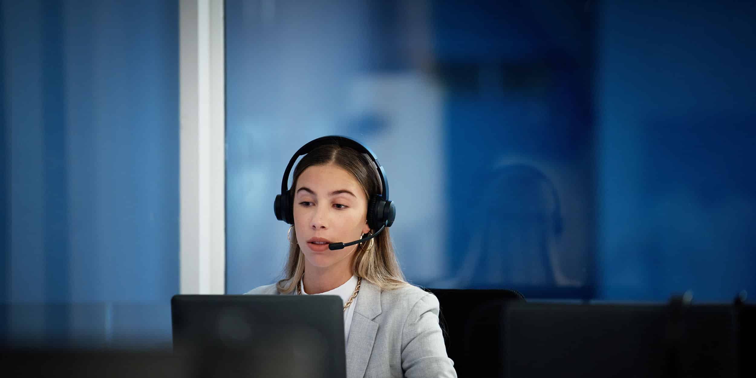 Business woman, call center and laptop for communication, technical support and information technology advice at night. Professional agent, consultant or advisor speaking on computer at tech company.