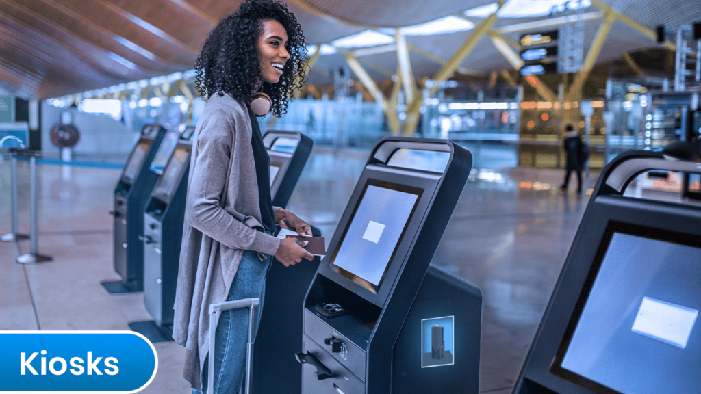 A woman stands at an ATM machine in the airport, unlocking business potential.
