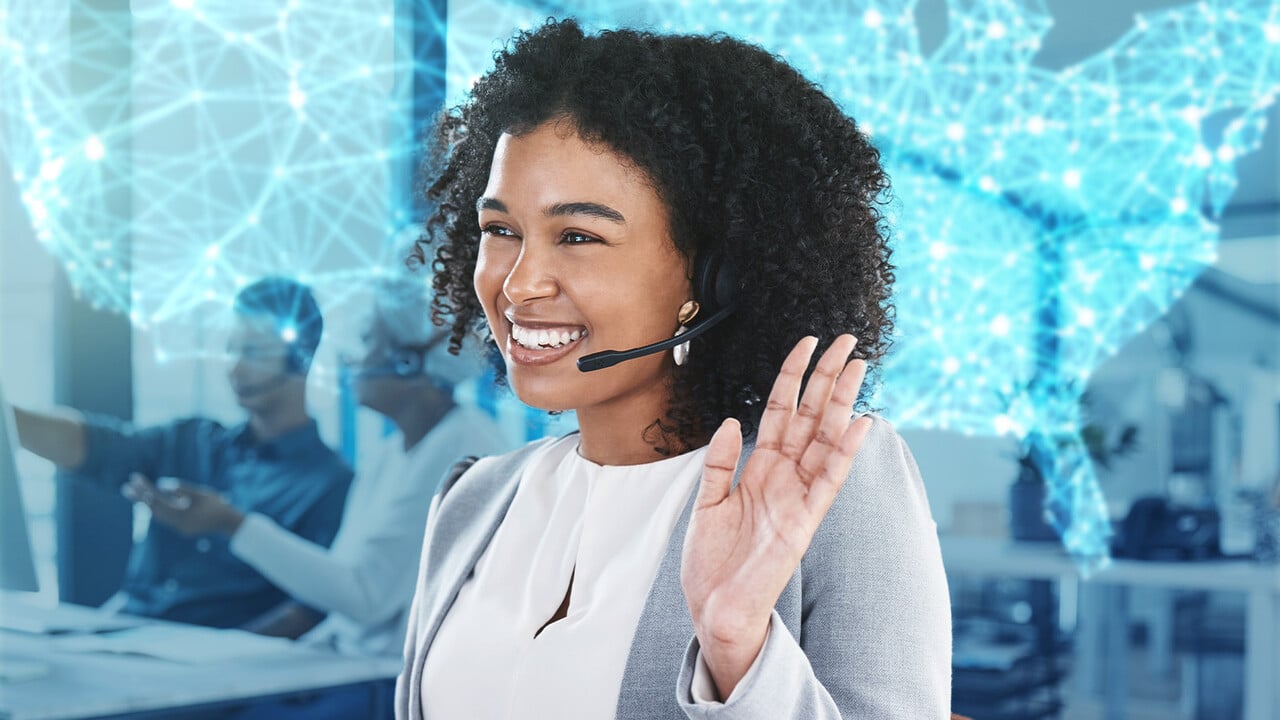 Customer service representative with headset smiling and gesturing in a modern office environment, protected by Azulle Security Licenses for business safety.