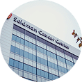 Exterior view of a building with large windows, displaying the sign "Solomon Cancer Center" near the top.