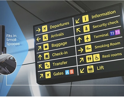 Black airport sign with yellow and white icons and text indicates directions for departures, arrivals, baggage, check-in, transfer, gates, security, terminals, restrooms, and lift.