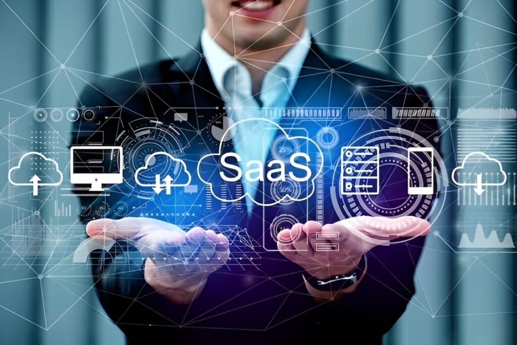 A person in a suit holds out hands with digital SaaS (Software as a Service) icons and diagrams overlaid, representing cloud computing technology.