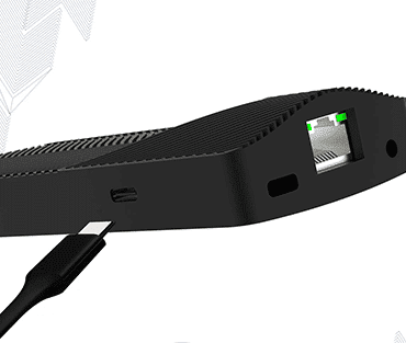 A black device connected to a USB cable, positioned on a flat surface.