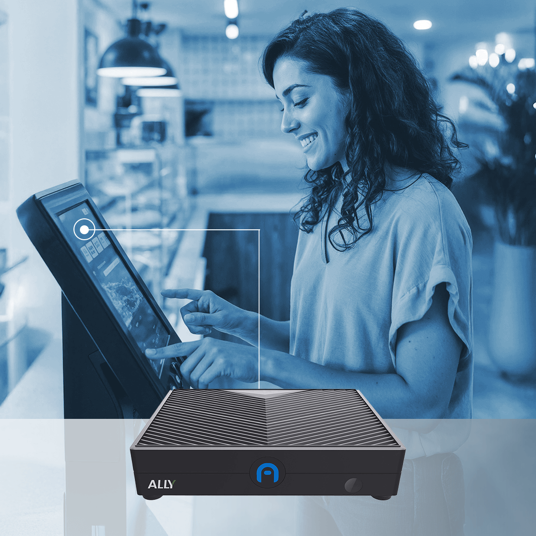 A woman uses a touchscreen kiosk while a small electronic device labeled "ALLY" is shown prominently in the foreground.